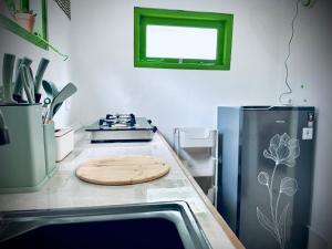 a kitchen with a wooden cutting board on the counter at Kaktus bungalow in Gili Islands