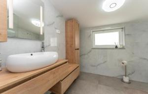 a bathroom with a white sink and a window at Villa Emine in Banj +20 photos