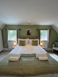 a bedroom with a large bed with two pillows at Stags Head Inn in Yarlington