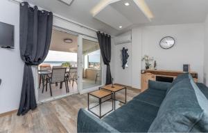 a living room with a blue couch and a table at Villa Emine in Banj