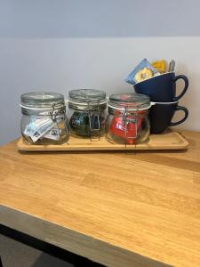 a wooden tray with jars of food on a table at Stags Head Inn in Yarlington