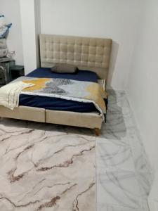 a bedroom with a bed with a marble floor at The cheapest room closest to Istanbul airport in Arnavutköy