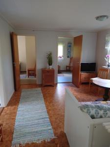 a living room with a couch and a table at Stuga vad vatten in Åsarp