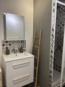 a bathroom with a sink and a mirror at Casa Straboni Corte in Corte +4 photos