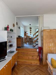 a living room with a kitchen and a dining room at Bogács Hilóczki Vendégház in Bogács