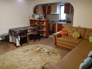 a living room with a couch and a table at Casa Tăslovan in Sărmaş