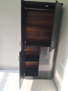 a wooden door in a room with a tile floor at Cozy Nest - Designed for All in Pune