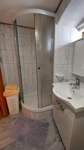 a bathroom with a shower and a sink at Family apartment in old town in Cres +23 photos