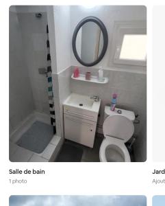 a bathroom with a white toilet and a mirror at chalet typique 50 m de la mer in Gruissan