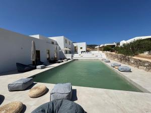 a swimming pool in the middle of a house at Antiparos Gems in Agios Georgios