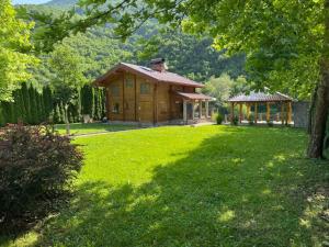 a small wooden house in a field of grass at Villa Lavanda in Banja Luka
