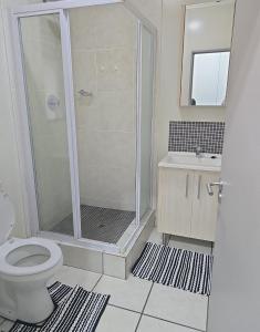 een badkamer met douche, toilet en wastafel bij Eden Place in Vosburg