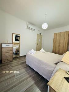 a bedroom with a large bed and a dresser at Descanso de Dulcinea in Almagro +20 photos