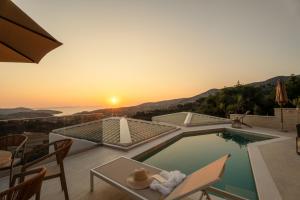 a villa with a swimming pool and a sunset at DK Luxury Villas in Syvota