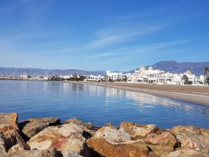 a beach with rocks and buildings in the background at Apartamento en Ejido Centro in El Ejido