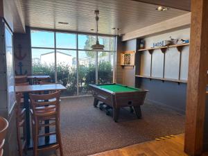a room with a pool table and a bar at Ultimate serene getaway in East Mersea