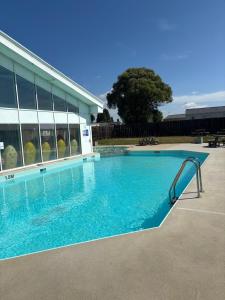 a swimming pool with a slide in front of a building at Ultimate serene getaway in East Mersea