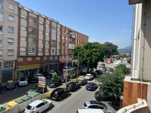 a city street filled with parked cars and buildings at Garden Beach Apartament in Boiro