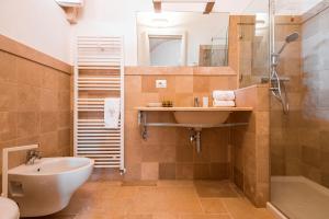 a bathroom with a sink and a toilet and a shower at Masseria Romanelli Noya Agriturismo in Monopoli