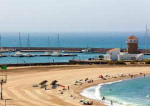a group of people on a beach near the water at Apartamento en Ejido Centro in El Ejido +12 photos