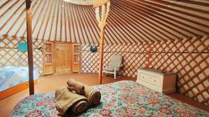 a bedroom with a bed and a chair in a yurt at Tulpa Cádiz in Malcocinado +167 photos