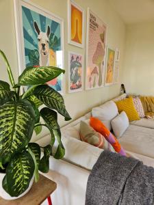 a living room with a couch and a plant at Lägenhet med havsutsikt i Helsingborg in Helsingborg
