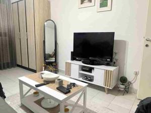 a living room with a tv and a table at Sivas Bar in Bar +4 photos