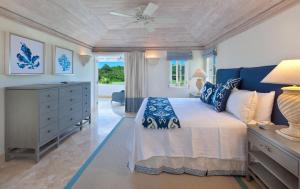 a bedroom with a bed and a ceiling fan at Royal Westmoreland - Villa Grove home in Saint James