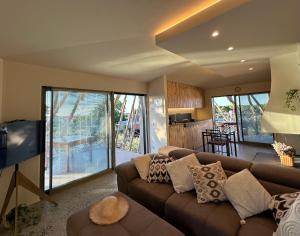 a living room with a brown couch and a tv at Trabocco in Campagna in Lanciano