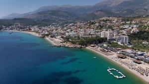 an aerial view of a beach with boats in the water at Vironas Hotel in Himare