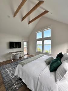 a bedroom with a large bed and a large window at Exclusive Lakefront Retreat on Douglas Lake in Dandridge