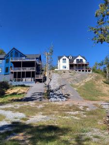 a large house on top of a hill at Exclusive Lakefront Retreat on Douglas Lake in Dandridge +76 photos