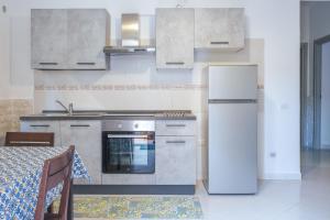 a kitchen with a stove and a refrigerator and a table at Vietri House 88 in Vietri sul Mare