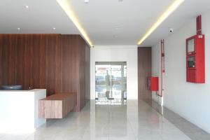 a lobby with a desk and a red box on the wall at sohho Hotel in Cukai