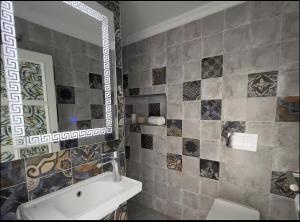 a bathroom with a sink and a mirror at Luxurious apartment close to all amenities in Agadir