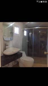 a bathroom with a toilet and a sink at NVH4 Nanay Vacation Home Coron Palawan in Coron