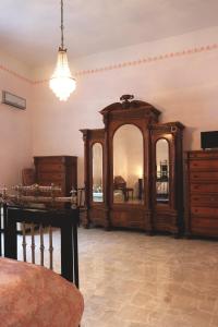 a room with wooden furniture and a chandelier at Zia Sisina - Dimora Storica in Barile