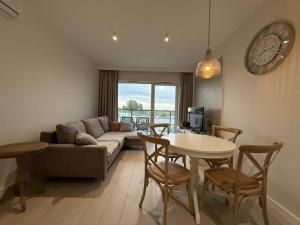 a living room with a couch and a table at Cosmo Apartments Baltic Sea in Gdańsk +10 photos