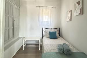 a small bedroom with a bed and a window at Metaxana in Chatzirados
