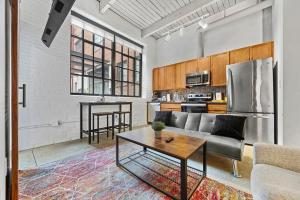 una sala de estar con un sofá y una mesa en Brooklyn Style Loft l DT l Parking l Cafe, en Cleveland