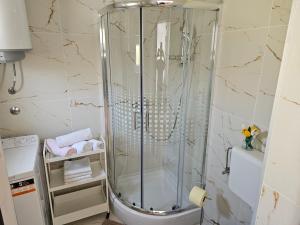 a shower with a glass door in a bathroom at Apartment Klara in Senj +23 photos