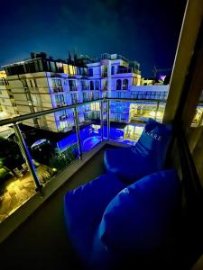 a balcony with blue chairs in front of a building at Apartment B48 in Tarsis Club Complex in Sunny Beach