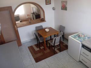 a kitchen with a table and a small table and chairs at MAM apartmani in Bosanski Brod +11 photos