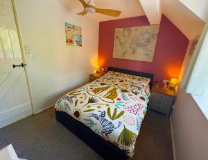 a bedroom with a bed with a colorful comforter at Captain Cook Riverside Walk in Whitby