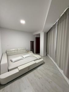 a white bedroom with a large bed in it at M&D Apartment in Struga