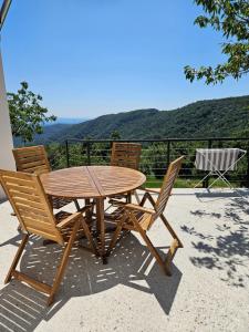 a wooden table and chairs sitting on a patio at Viktor Estate in Deskle