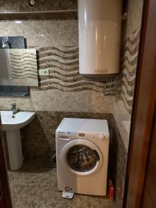 a small bathroom with a toilet and a sink at Friends & Family II in Yerevan +4 photos