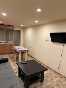 a living room with a couch and a flat screen tv at Friends & Family II in Yerevan