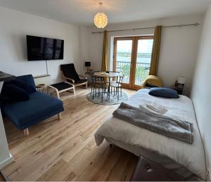 a bedroom with a bed and a table and chairs at Key West Suites in Wexford