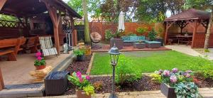 a backyard with a garden with flowers and a patio at Willa Krystal in Ciechocinek